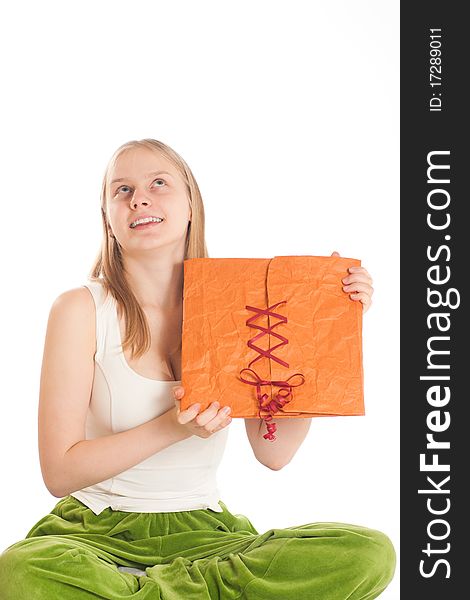 Young attractive woman sit with gift bag and dreaming