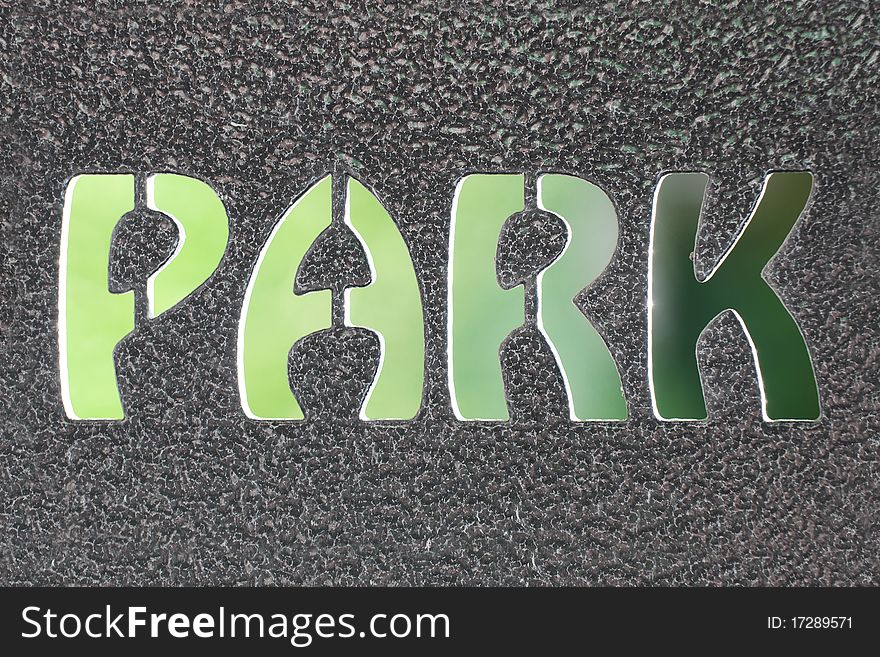 Park sign formed by steel and blurred natural green background.
