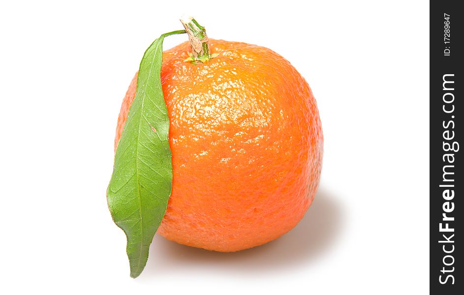 Mandarin with a leaf isolated over white background