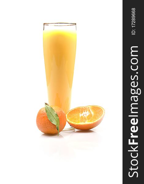 A glass of fresh orange juce with a ripe mandarin isolated over white