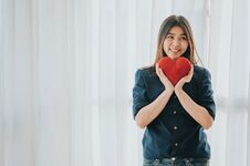 Happy Asian Woman Holding Red Heart Stock Photography