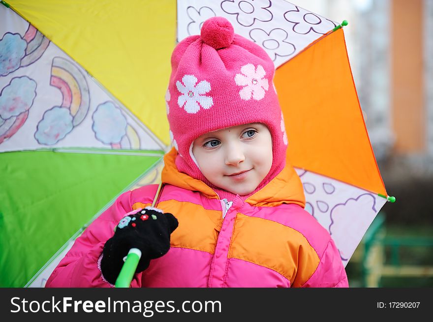 Adorable small girl in colorful warm clothers