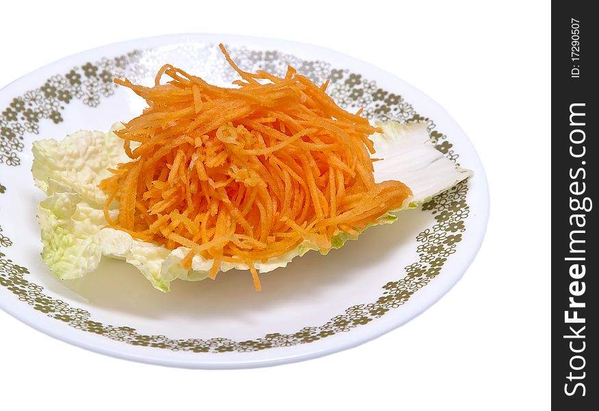 Fresh grated carrots on a salad leaf