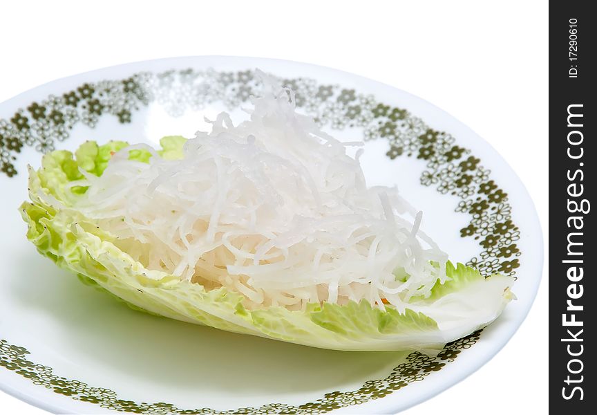 Fresh grated daikon radish on a piece of lettuce