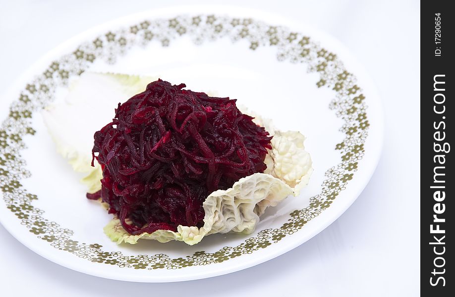 Boiled grated beets on a piece of lettuce