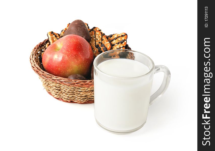 Cup of milk and cookies with apple in the basket for healthy breakfast