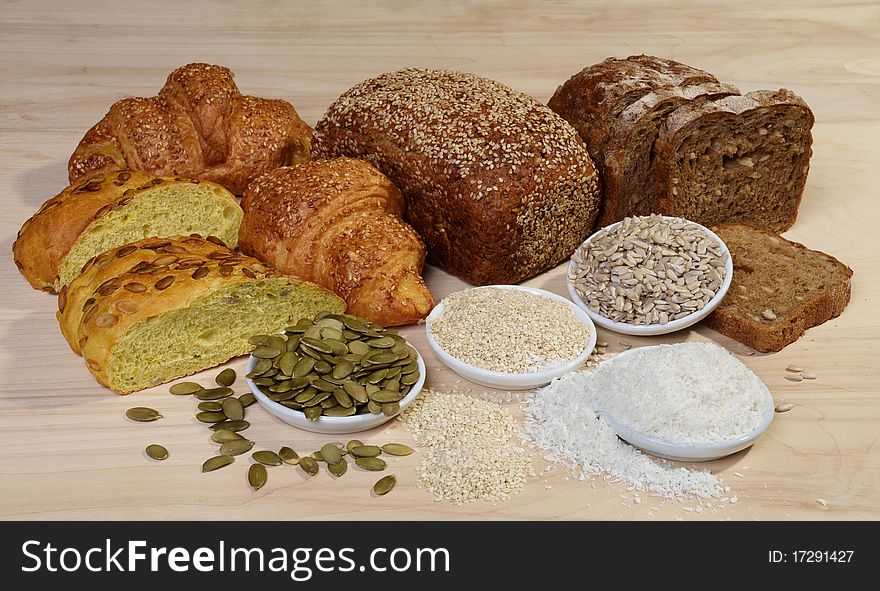 Variety of bread and ingredients on wooden background