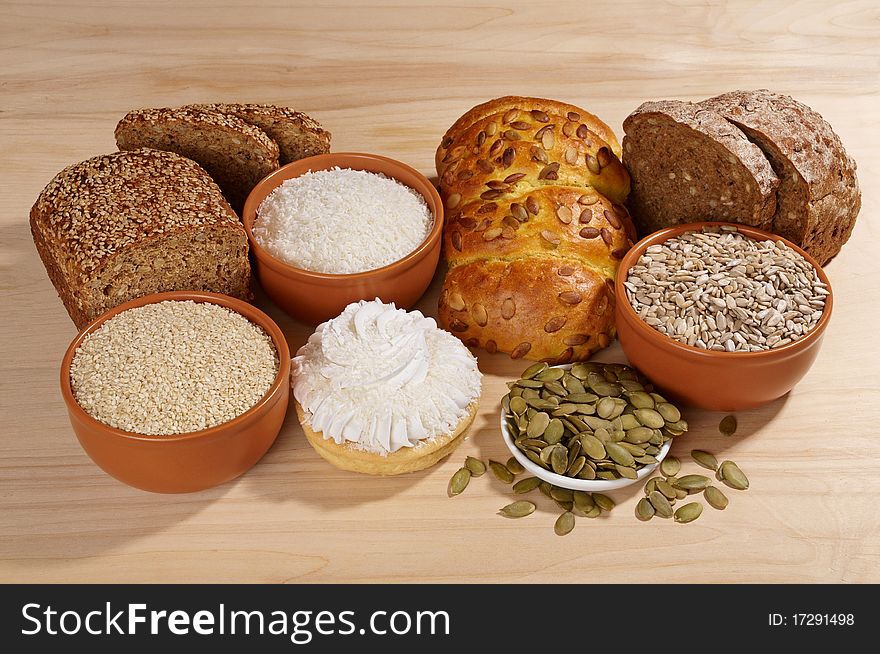 Variety of bread and ingredients on wooden background