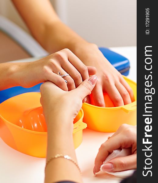 Young woman getting a manicure in a nail salon.