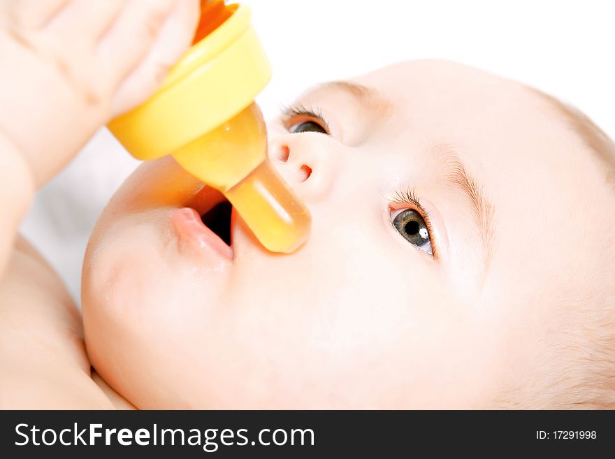 Baby drinking from a bottle. Focus on eye.