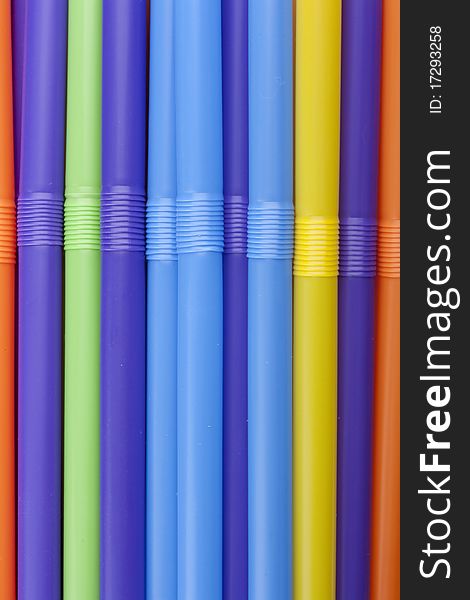 Plastic tubes of different colors in the background.