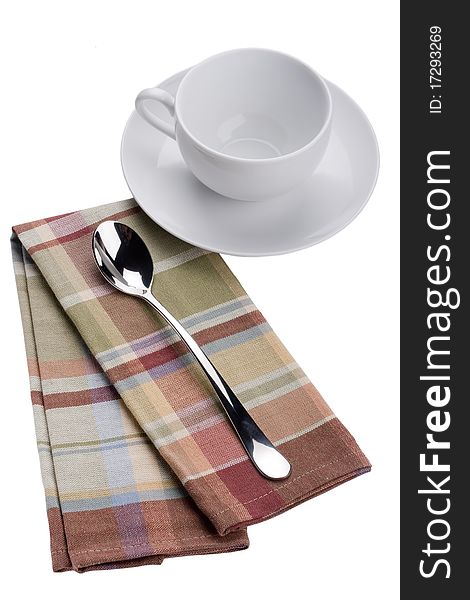 Two spoons on a checkered cloth, tissue.