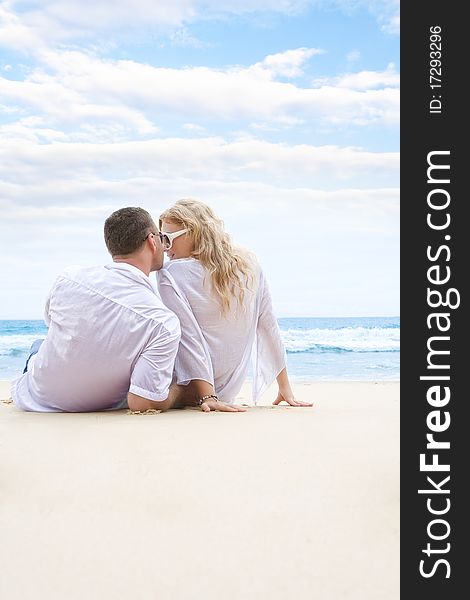 Portrait of young nice couple having good time on the beach