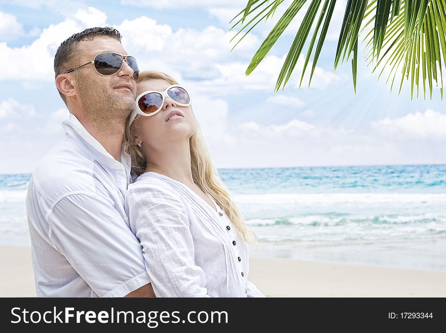 Portrait of young nice couple having good time on the beach. Portrait of young nice couple having good time on the beach