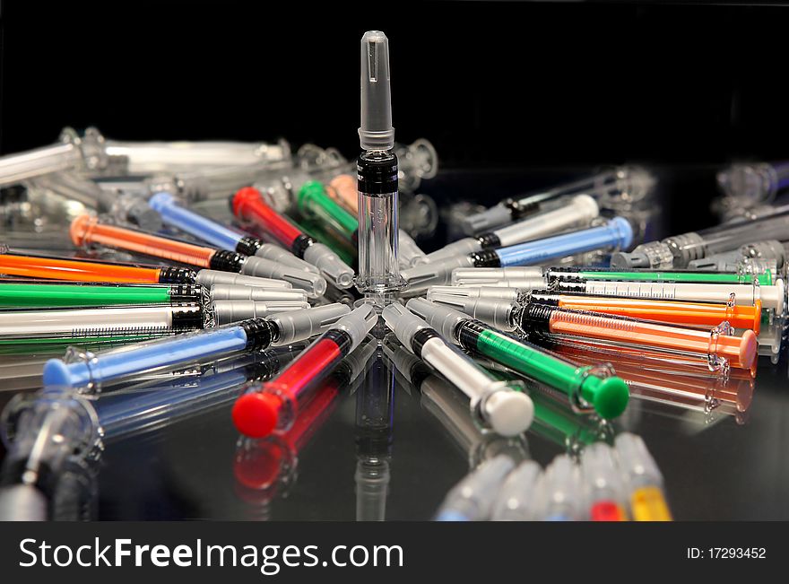 Modern syringes for medicine injections on a black background