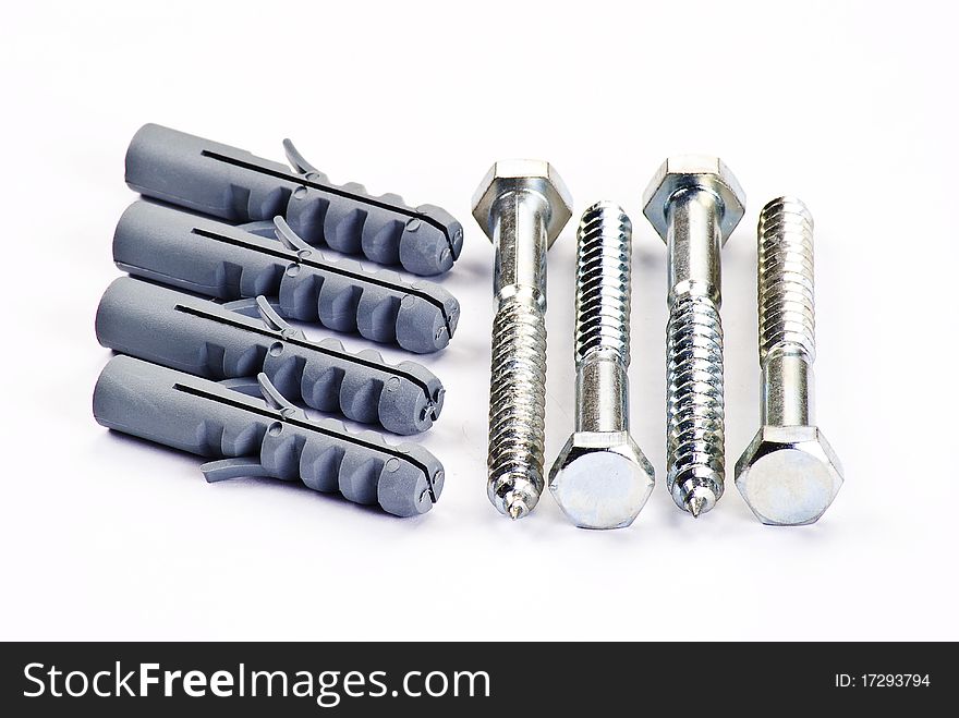 Raw plugs and bolts over white background. Raw plugs and bolts over white background