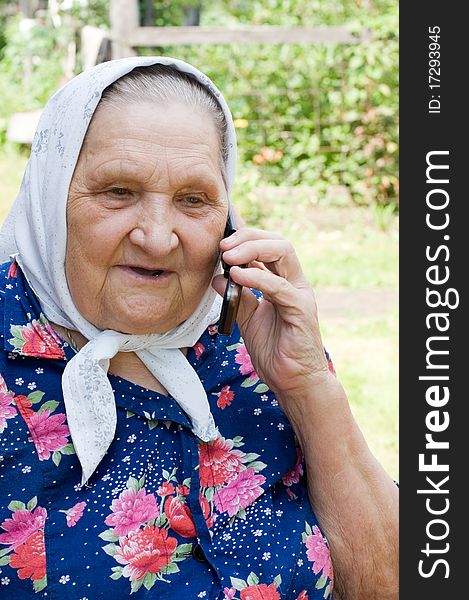 Grandmother talking with a phone outdoor