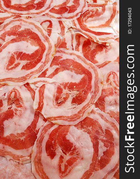 Slices of bacon rolled up ready for use in the kitchen