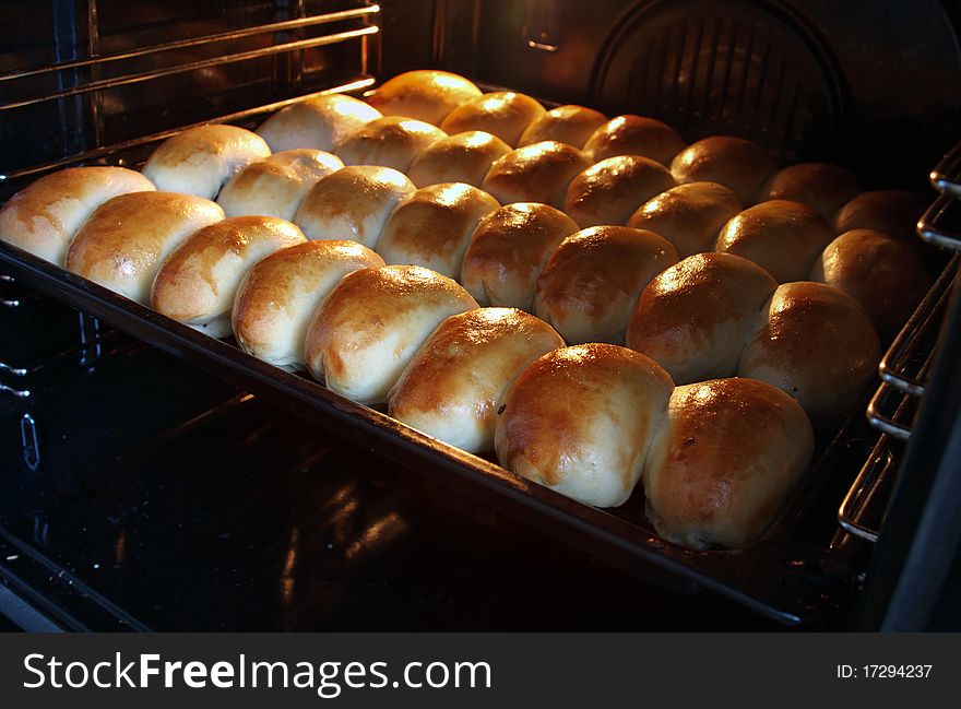 Freshly baked pastries in the oven with focus on the first row