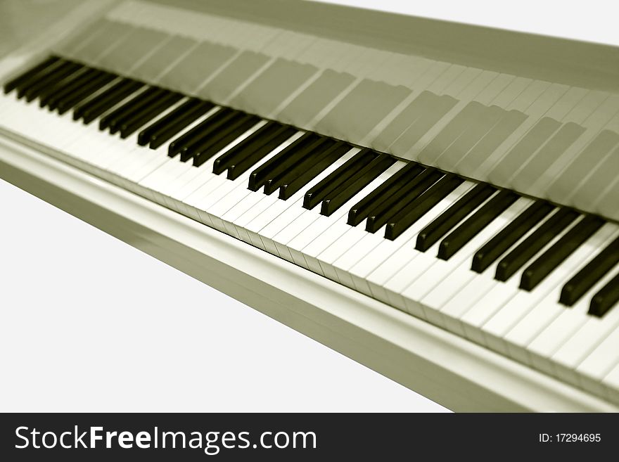 White grand piano with the open keyboard close up