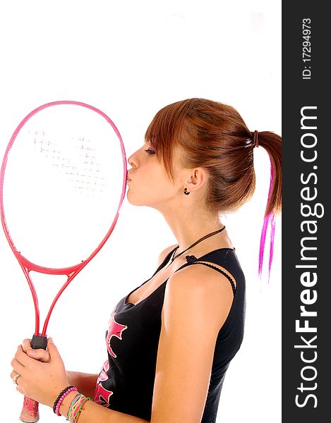 A young tennis player symbolically kisses his tennis racket. A young tennis player symbolically kisses his tennis racket