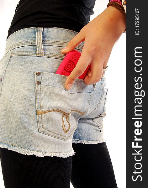 A young girl pulls the phone out of the pockets of his jeans hot pants. A young girl pulls the phone out of the pockets of his jeans hot pants