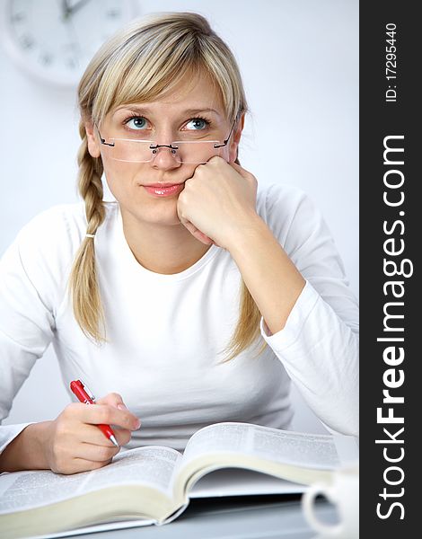 Portrait of Intelligence girl student reading  book in classroom