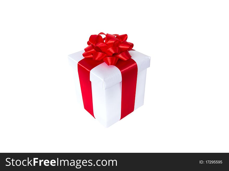 White gift box with red ribbon and bow isolated on white