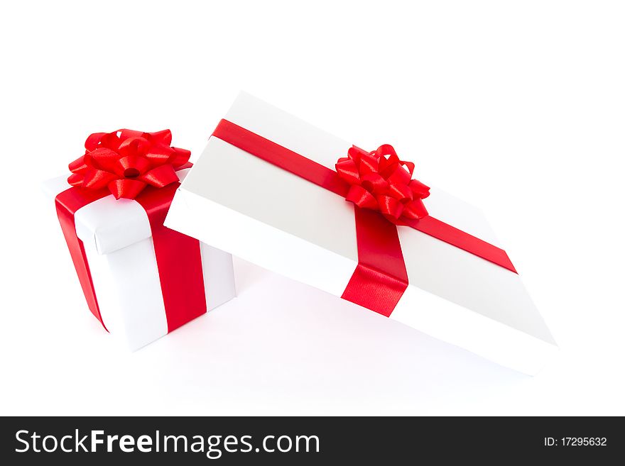 White gift boxes with red ribbon and bow isolated on white