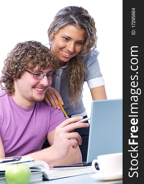 Teenage boy and girl sitting in front of a laptop and do a fun learning. Teenage boy and girl sitting in front of a laptop and do a fun learning