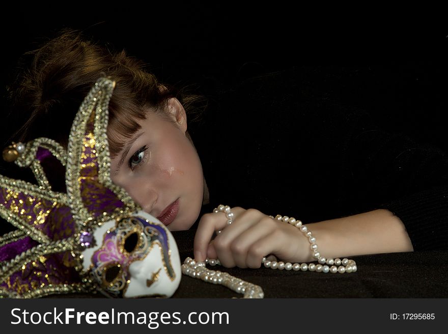 A beautiful young woman with a masquerade mask. A beautiful young woman with a masquerade mask