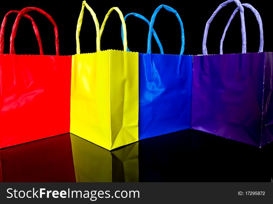 Set of multi colored gift bags isolated on black background. Set of multi colored gift bags isolated on black background