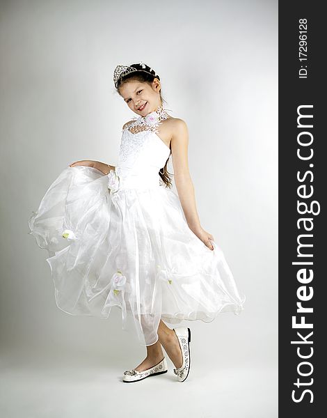 A girl of eleven years in a smart white princess dress. A girl of eleven years in a smart white princess dress