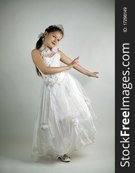 A girl of eleven years in a smart white princess dress. A girl of eleven years in a smart white princess dress
