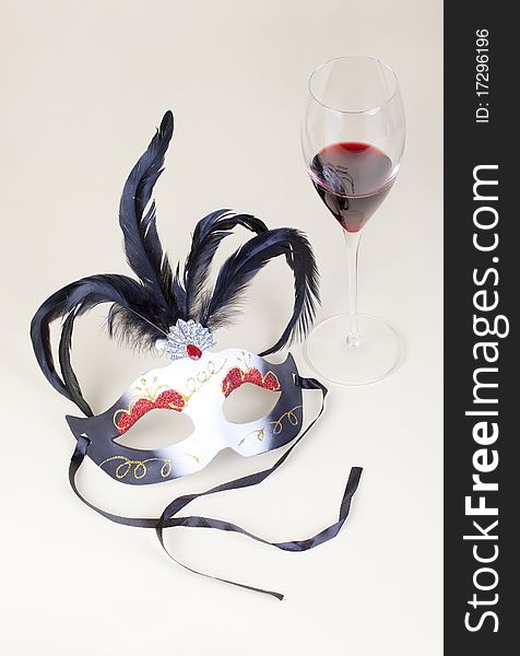 Carnival mask and glass of wine