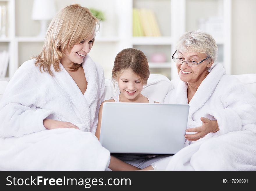 Attractive family is looking into a laptop. Attractive family is looking into a laptop