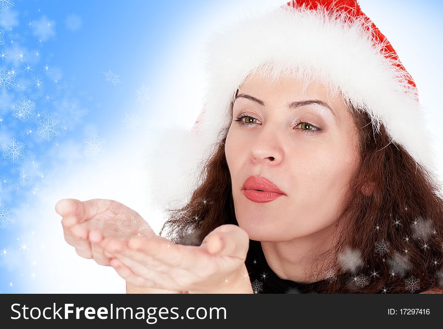 Portrait of christmas girl blows off snowflakes from the hands. Portrait of christmas girl blows off snowflakes from the hands