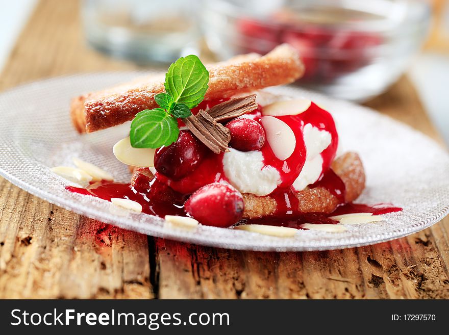 Fan-shaped puff pastries with cream, cranberries and syrup. Fan-shaped puff pastries with cream, cranberries and syrup