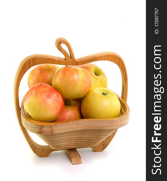 Apples in wooden bowl on white background
