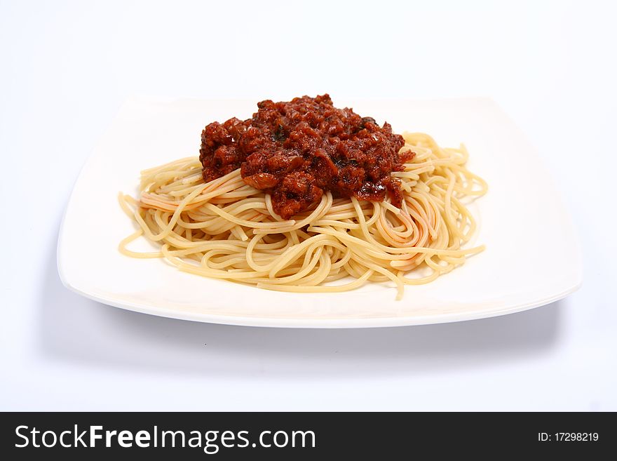 Pasta with bolognese sauce on a plate on white background