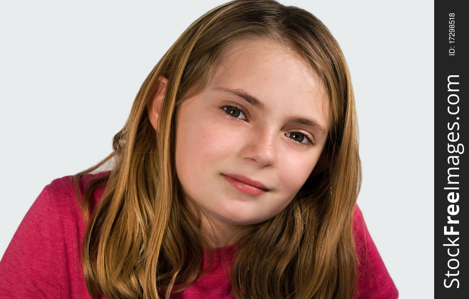 Soft focus portrait of pretty preteen girl with slight smile looking at camera. Soft focus portrait of pretty preteen girl with slight smile looking at camera