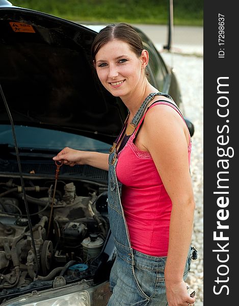 Young woman repairing her car. Young woman repairing her car