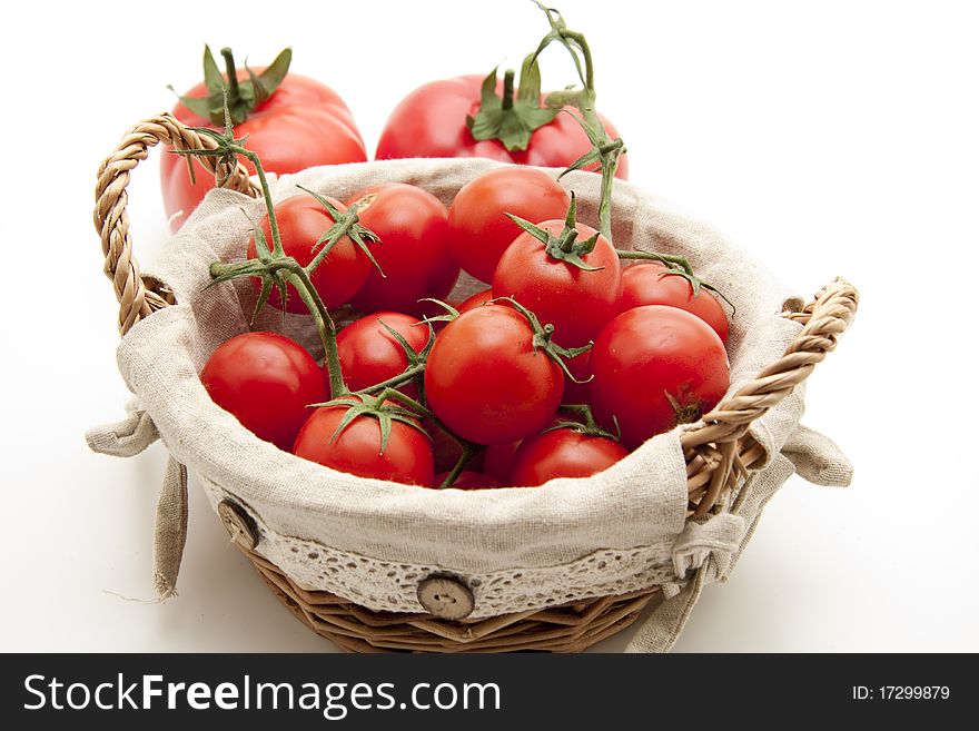 Cocktail tomatoes in the basket with material