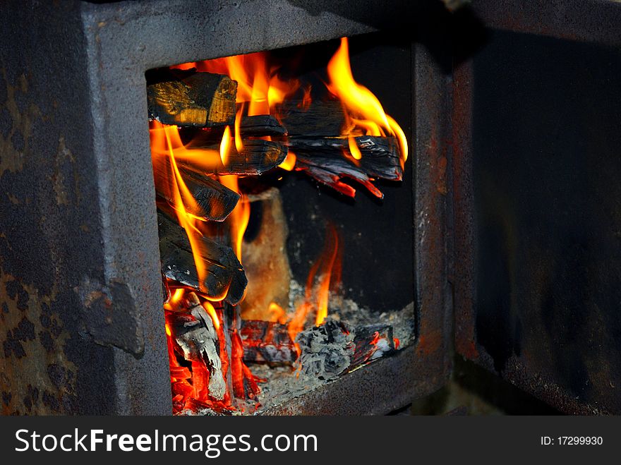 Burning fire wood in the brick furnace. Burning fire wood in the brick furnace