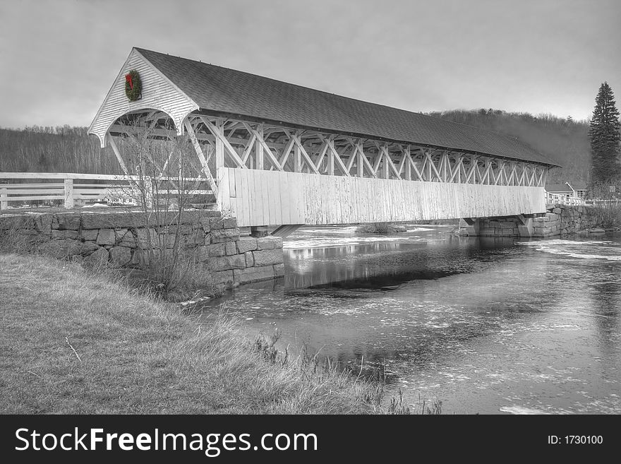 An old new england covered bridge in northern new hampshire in duotone black and white. An old new england covered bridge in northern new hampshire in duotone black and white
