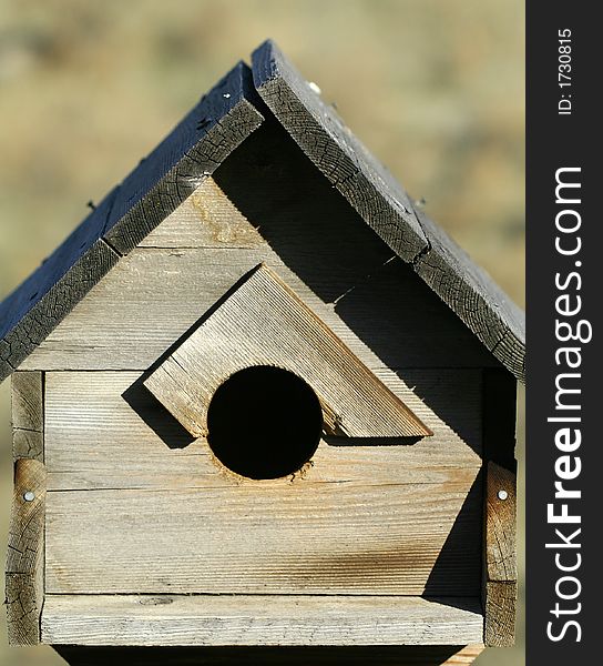 An old weathered wooden birdhouse