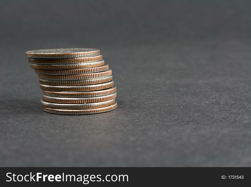 A stack of quarters on a dark background. A stack of quarters on a dark background