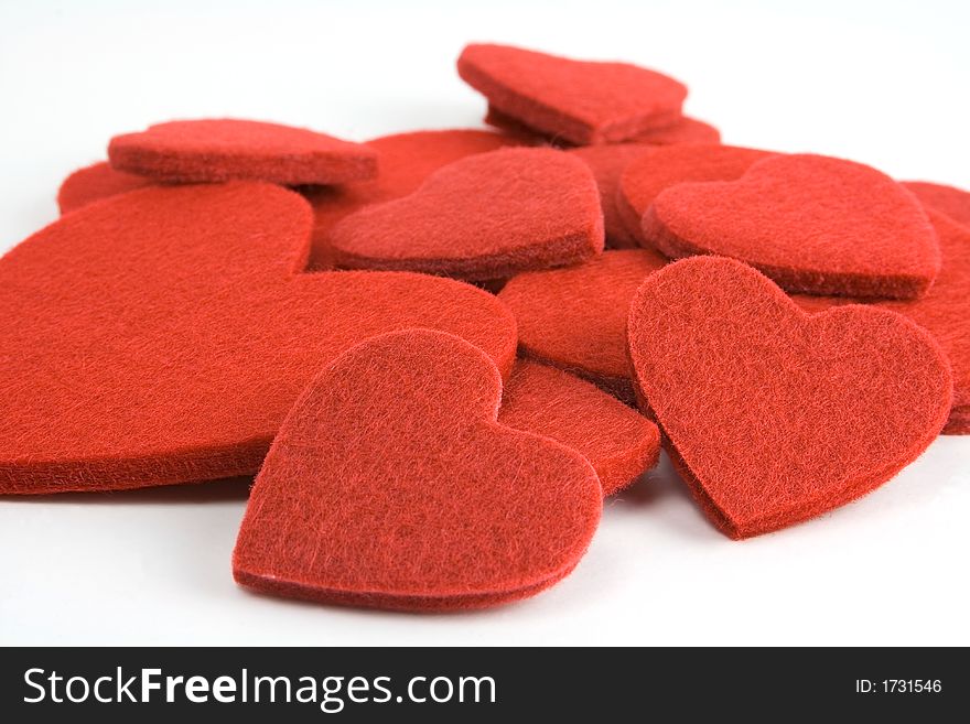 A pile of red felt hearts. A pile of red felt hearts