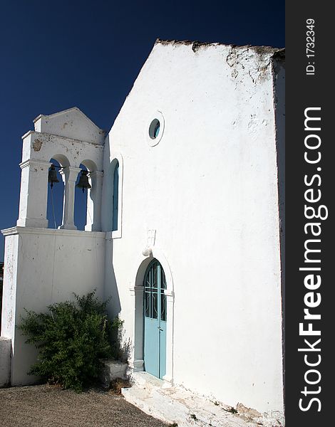 White greek church with campanile and two bells