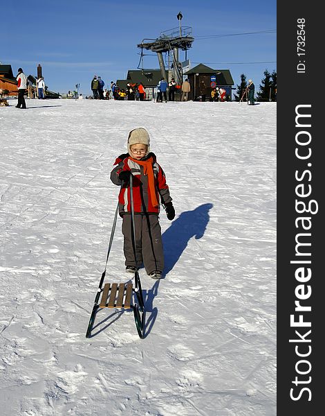 Boy with sled in winter time